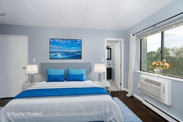 bedroom featuring a baseboard heating unit, baseboards, a wall unit AC, and wood finished floors