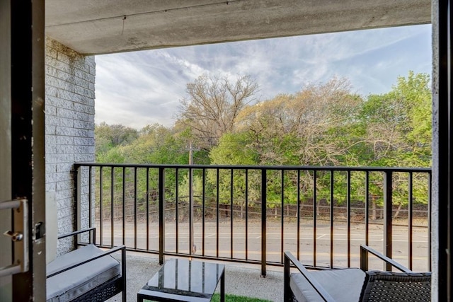 balcony featuring a view of trees
