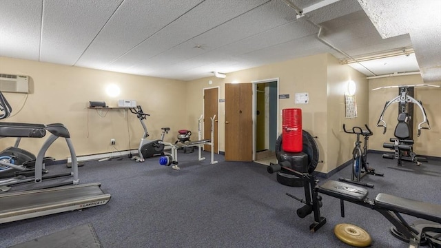 workout area featuring a wall mounted air conditioner