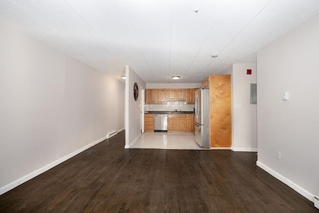 unfurnished living room with light wood-type flooring and baseboards