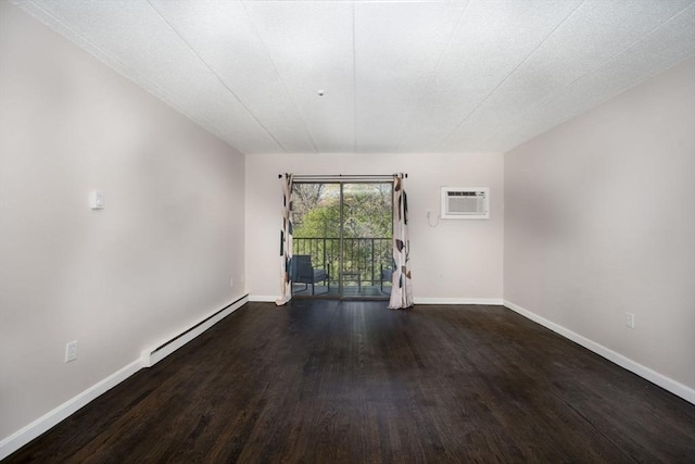 empty room with a baseboard radiator, baseboards, a wall unit AC, and wood finished floors