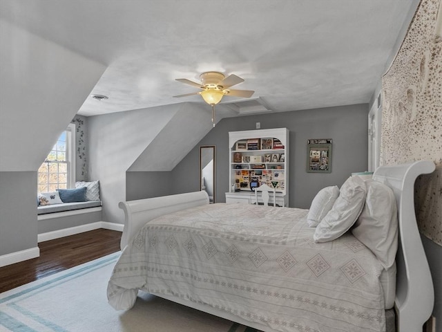 bedroom with a ceiling fan, baseboards, vaulted ceiling, and wood finished floors