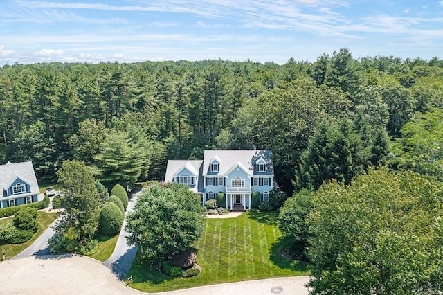 birds eye view of property with a view of trees