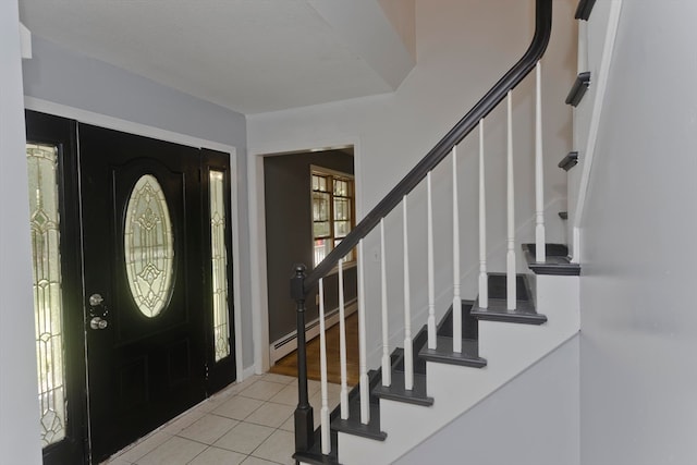 tiled foyer entrance featuring a baseboard heating unit