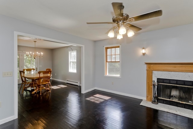 living room featuring a baseboard radiator, ceiling fan with notable chandelier, a premium fireplace, and dark hardwood / wood-style flooring