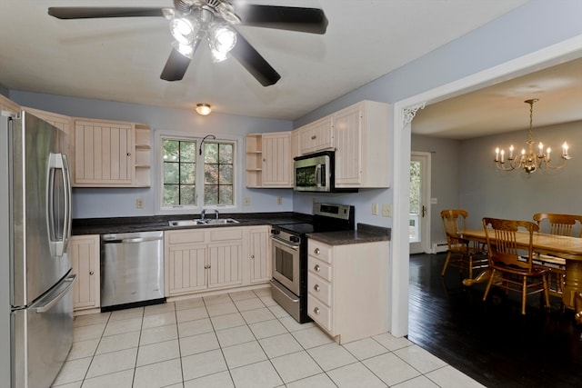 kitchen with light hardwood / wood-style floors, sink, ceiling fan with notable chandelier, hanging light fixtures, and appliances with stainless steel finishes