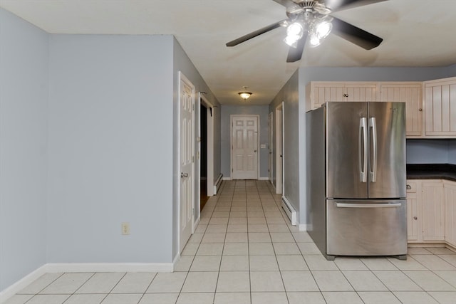 kitchen with stainless steel refrigerator, a baseboard radiator, light tile patterned floors, ceiling fan, and light brown cabinetry