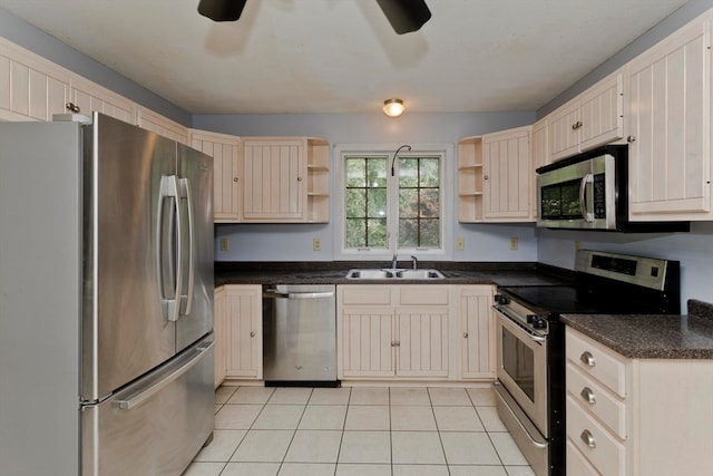 kitchen with light tile patterned floors, sink, ceiling fan, and stainless steel appliances