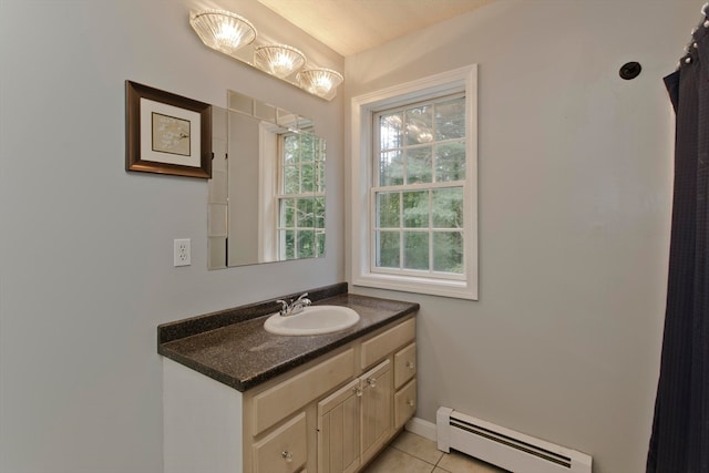 bathroom with vanity, a baseboard radiator, and tile patterned flooring