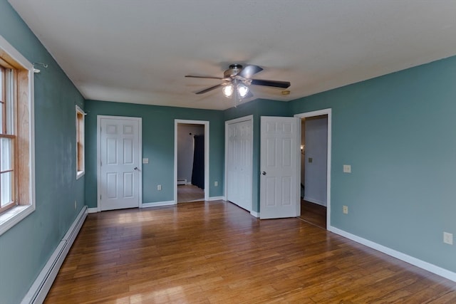 unfurnished room featuring hardwood / wood-style flooring, ceiling fan, and a baseboard radiator