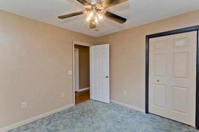 unfurnished bedroom with light carpet, ceiling fan, and a closet