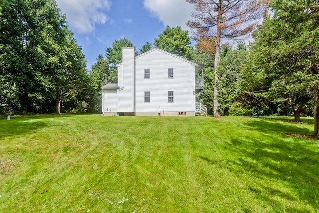 view of side of home with a lawn