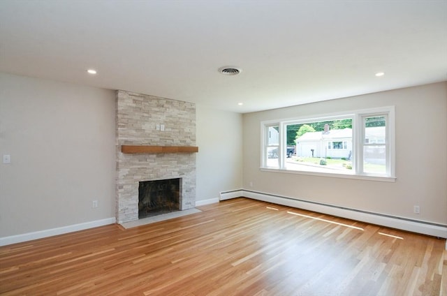 19 Woodcliff Rd, Holbrook, MA 02343 - unfurnished living room with baseboard heating, wood finished floors, a stone fireplace, baseboards, and recessed lighting
