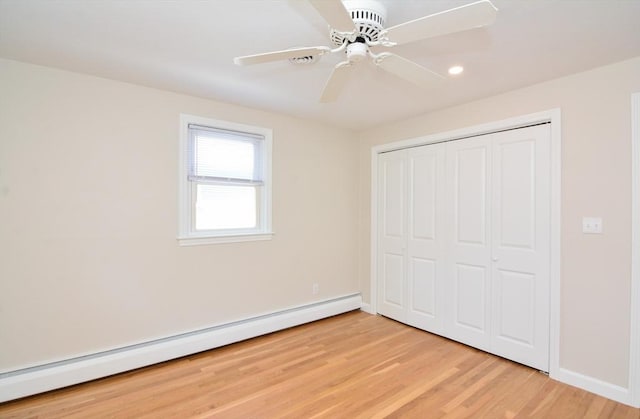 19 Woodcliff Rd, Holbrook, MA 02343 - unfurnished bedroom featuring a baseboard heating unit, baseboards, light wood-type flooring, a closet, and recessed lighting