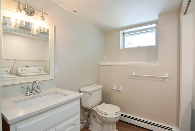 19 Woodcliff Rd, Holbrook, MA 02343 - half bath with baseboard heating, toilet, vanity, washing machine and dryer, and wood finished floors