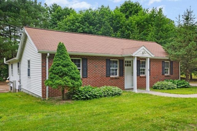 31 Granite St, Walpole, MA 02081 - view of front facade featuring brick siding, a front yard, and a shingled roof
