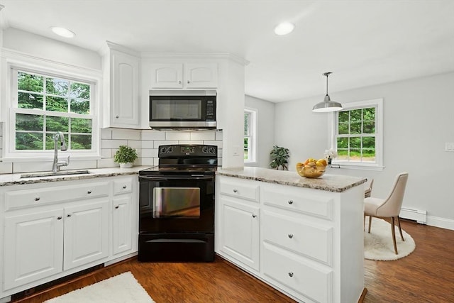 31 Granite St, Walpole, MA 02081 - kitchen with stainless steel microwave, black range with electric stovetop, light stone countertops, dark wood-style floors, and backsplash