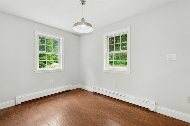 31 Granite St, Walpole, MA 02081 - empty room with a baseboard heating unit, plenty of natural light, and dark wood-style flooring