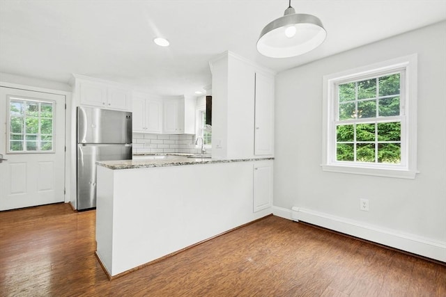 31 Granite St, Walpole, MA 02081 - kitchen with freestanding refrigerator, baseboard heating, a peninsula, white cabinetry, and light stone counters