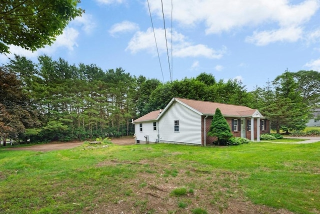 31 Granite St, Walpole, MA 02081 - view of side of property featuring a yard and brick siding