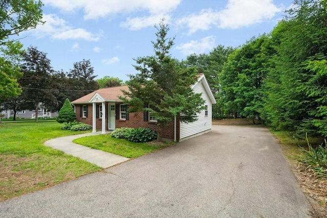 31 Granite St, Walpole, MA 02081 - view of front of house featuring brick siding, a front yard, and asphalt driveway