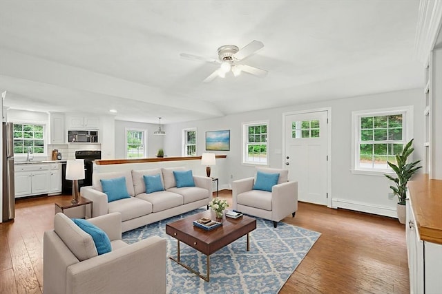 31 Granite St, Walpole, MA 02081 - living room featuring a baseboard radiator, healthy amount of natural light, and wood finished floors