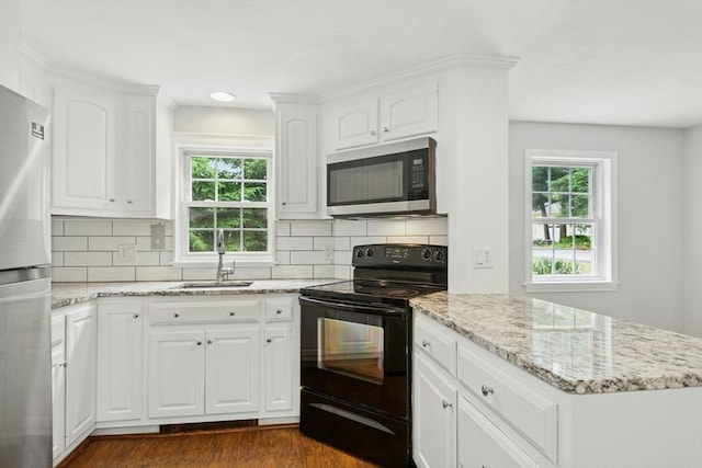 31 Granite St, Walpole, MA 02081 - kitchen featuring appliances with stainless steel finishes, dark wood-type flooring, light stone counters, decorative backsplash, and white cabinets