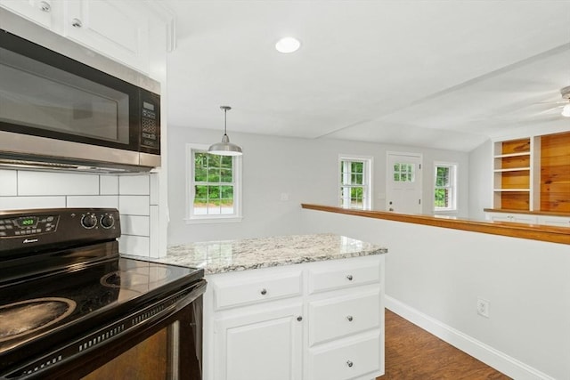 31 Granite St, Walpole, MA 02081 - kitchen featuring black electric range oven, stainless steel microwave, white cabinetry, dark wood-style flooring, and a peninsula