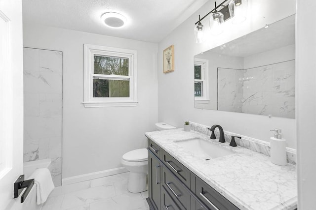 bathroom featuring vanity, toilet, a textured ceiling, and a tile shower