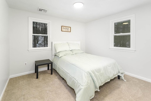 bedroom with light colored carpet