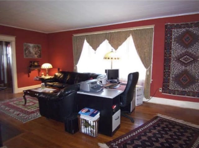 living room with hardwood / wood-style flooring and ornamental molding