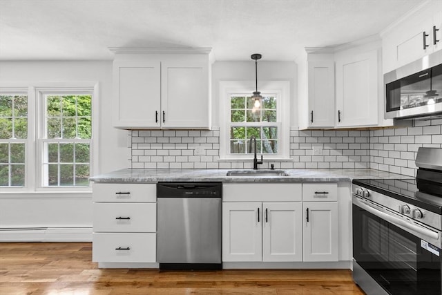 6 Walter St, Norton, MA 02766 - kitchen featuring appliances with stainless steel finishes, a sink, healthy amount of natural light, and white cabinetry
