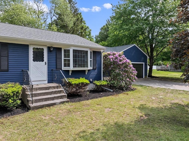 6 Walter St, Norton, MA 02766 - view of front of house featuring an outbuilding, a front lawn, a garage, and a shingled roof