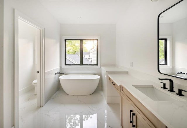 230 Auburn St Unit 230, Newton, MA 02466 - bathroom featuring vanity, a freestanding tub, toilet, and marble tiled flooring