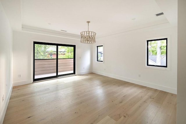 230 Auburn St Unit 230, Newton, MA 02466 - unfurnished room with a chandelier, baseboards, light wood-type flooring, and a raised ceiling