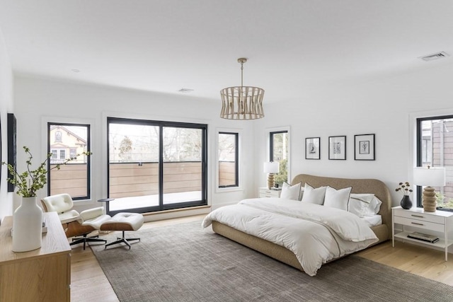 230 Auburn St Unit 230, Newton, MA 02466 - bedroom featuring light wood-style floors and a chandelier