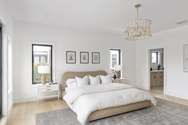 230 Auburn St Unit 230, Newton, MA 02466 - bedroom with light wood-style floors, multiple windows, baseboards, and ensuite bath