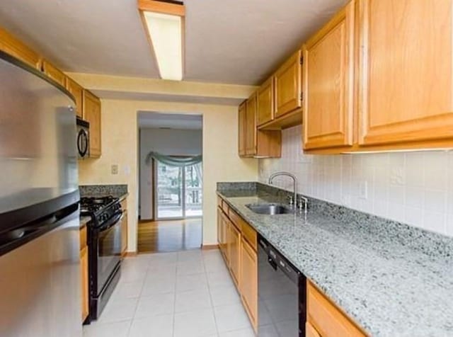 6 Tisdale Dr Unit 6, Dover, MA 02030 - kitchen with black appliances, tasteful backsplash, light stone countertops, and light tile patterned floors