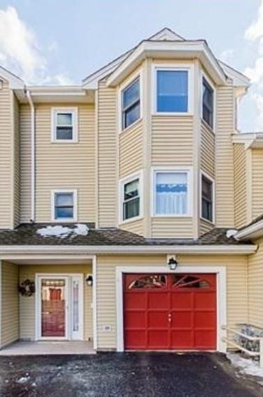6 Tisdale Dr Unit 6, Dover, MA 02030 - view of property with an attached garage and asphalt driveway