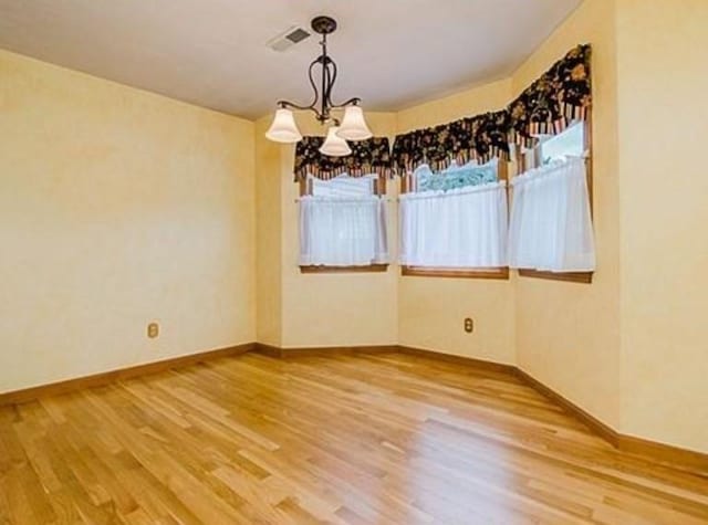 6 Tisdale Dr Unit 6, Dover, MA 02030 - unfurnished dining area featuring a chandelier and wood finished floors