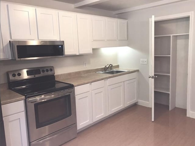 kitchen featuring white cabinets and appliances with stainless steel finishes