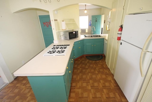 57 Edgewater Rd-, Waterfront, Hull, MA 02045 - kitchen featuring white appliances, a peninsula, a sink, arched walkways, and light countertops