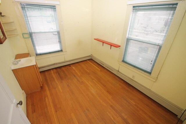 57 Edgewater Rd-, Waterfront, Hull, MA 02045 - unfurnished room with light wood finished floors, baseboard heating, and healthy amount of natural light