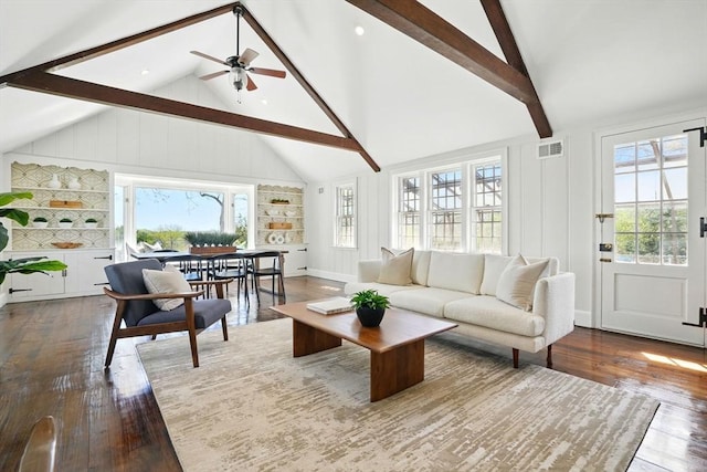 living area with visible vents, a ceiling fan, hardwood / wood-style floors, and beamed ceiling