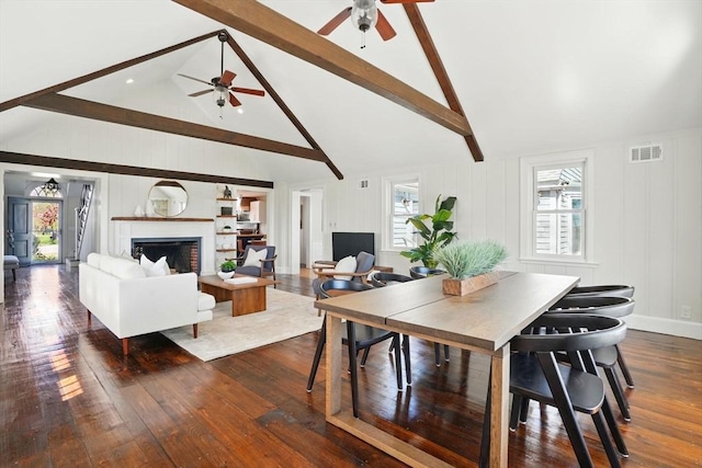 dining space featuring ceiling fan, beam ceiling, and high vaulted ceiling