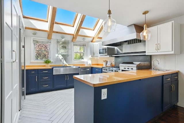 kitchen with butcher block countertops, a sink, and blue cabinets