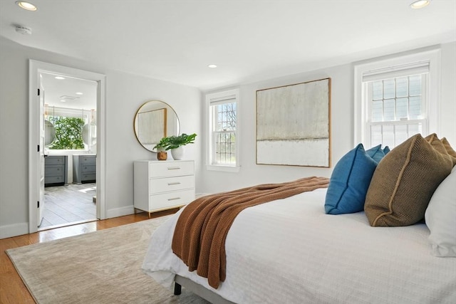 bedroom featuring recessed lighting, baseboards, connected bathroom, and wood finished floors