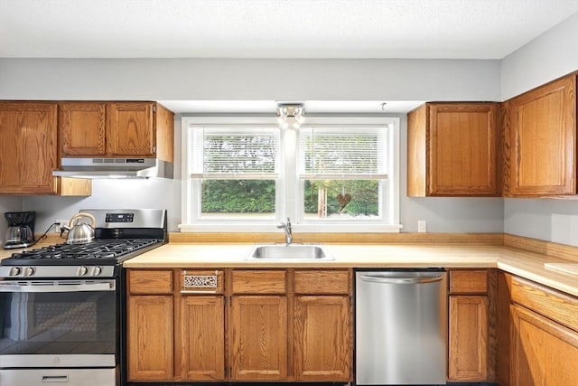 2500 Pendleton Ave Unit 2500, Chicopee, MA 01022 - kitchen with stainless steel appliances, under cabinet range hood, light countertops, and brown cabinetry