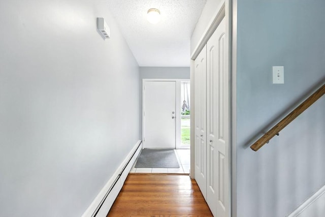 2500 Pendleton Ave Unit 2500, Chicopee, MA 01022 - doorway to outside featuring wood finished floors and a textured ceiling