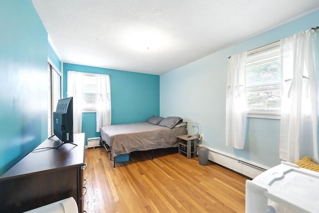 2500 Pendleton Ave Unit 2500, Chicopee, MA 01022 - bedroom featuring a baseboard radiator and wood finished floors